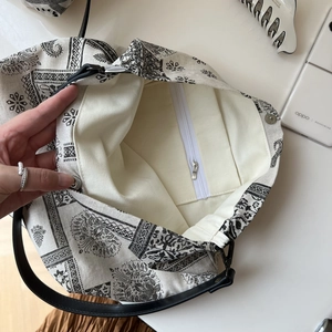 Detail view of cotton linen tote bag interior featuring zipper pocket and paisley print