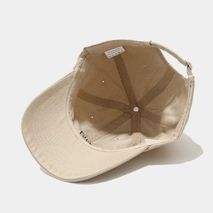 Inside view of khaki cotton baseball cap showing 1987 embroidery and adjustable strap