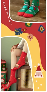 Detailed knit of festive red and green Christmas socks with Santa and reindeer motifs
