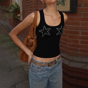 Close-up of black knitted tank top featuring silver rhinestone star patterns in outdoor light