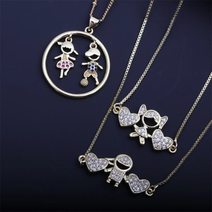 Detailed view of gold plated necklaces with boy and girl pendants set in colorful zircons