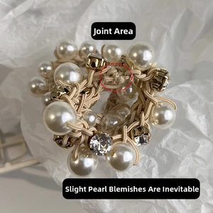 Detailed macro view of elastic hair tie featuring white pearls and faceted crystals
