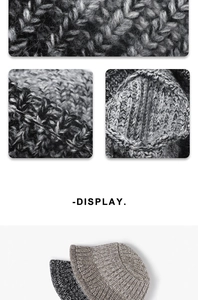 Detailed macro view of the thick cable knit texture and mixed gray wool yarn finish
