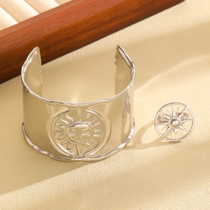 Detail of silver stainless steel sun relief bangle and hollow out matching ring set