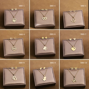 Detailed grid of gold-plated stainless steel jewelry sets with heart and floral motifs