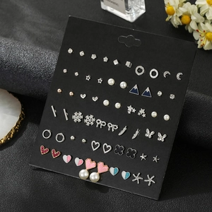 Set of 30 pairs of mixed alloy stud earrings with rhinestones and pearls on black card