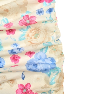 Detailed macro view of beige mesh fabric featuring elegant floral prints and pleated texture