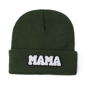Detail of forest green knitted beanie with white MAMA chenille patch embroidery