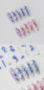 Detail view of 5D dragon nail art stickers with metallic beads on coffin fake nails