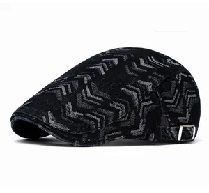 Detail of adjustable metal buckle on black denim beret with grey chevron pattern