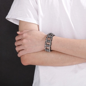 Close-up of vintage punk skull bracelet with braided dragon bone steel links