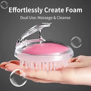 Transparent handle scalp massage brush with pink silicone bristles and ergonomic grip