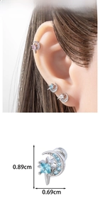 Detailed view of crescent moon and star cartilage stud earrings with inlaid zircon stones