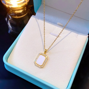 Minimalist gold titanium necklace with rectangular halo pendant and white inlay