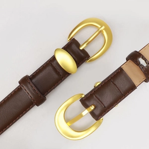 Two brown leather belts with gold oval metal buckles shown from a high angle view