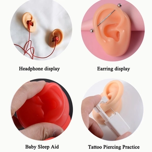 Silicone ear models in skin and red tones used for jewelry display and piercing practice