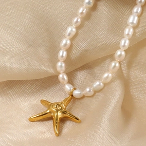 Elegant ocean style pearl necklace featuring a metallic gold starfish pendant on silk