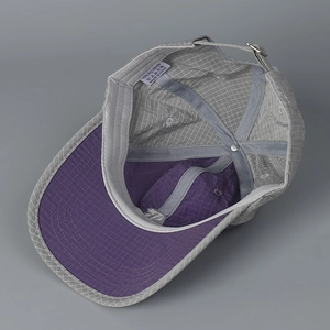 Quick-dry checkered baseball cap in grey and purple showing interior stitching and label