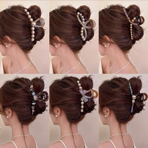 Showcase of six pearl and rhinestone hair clips on a girl's elegant braided hairstyle