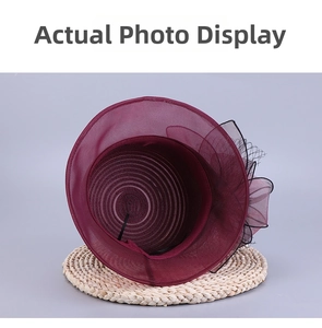 Detail view showing interior spiral stitching and burgundy organza flower on the sun hat