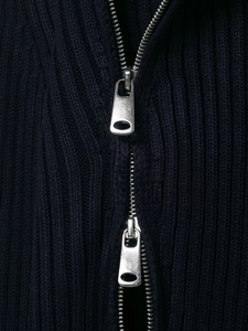 Detail of dark blue ribbed knit fabric with dual-way silver metallic zipper puller