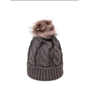 Detailed close-up of dark grey cable knit pattern and fluffy faux fur pom-pom on beanie
