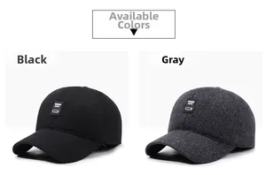 Detail of wool blend baseball caps in black and dark grey with rectangular woven labels