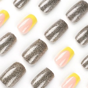 Yellow French tip press on nails with silver glitter accents and floral designs