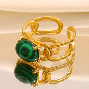 Detail of 18K gold-plated chunky chain ring with oval malachite stone in macro view