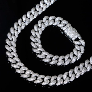 Close-up of a silver full iced-out 15mm Cuban link necklace and bracelet set
