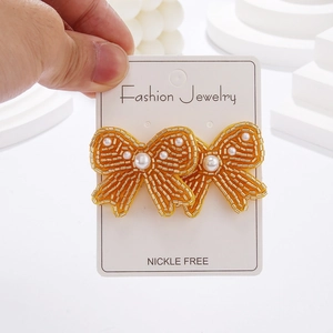 Bohemian bow-shaped yellow beaded stud earrings with white pearls for women