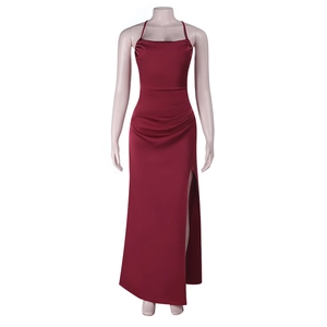 Detail of red backless satin evening gown featuring high slit and pleated waist design