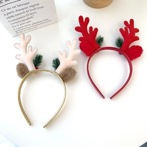Detail of Christmas reindeer antler headbands with glitter, bells and pine needle decor