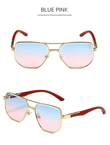 Detail of blue pink gradient lenses and wood grain temples on gold aviator sunglasses