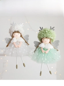 Close-up of angel girl ornaments featuring mesh skirts and festive antler headbands