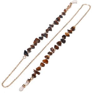 Detail of tiger eye stone eyeglass chain with gold metal links and silicone loops