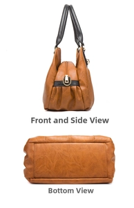 Detail view of brown leather handbag with black handles and reinforced bottom stitching