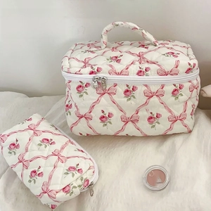 Floral quilted cosmetic bag set featuring pink roses and ribbon bow patterns