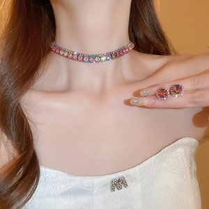 Detailed view of colorful rhinestone choker and matching stud earrings on model for women