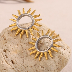 Chic 18K gold plated hollow sun-shaped stainless steel stud earrings on natural rock