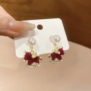 Elegant red rocking horse earrings with pearls and crystals for a festive look