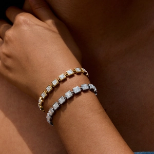 Close-up of gold and silver stainless steel tennis bracelets with square zirconia