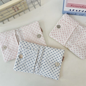 Detailed view of polka dot fabric passport holders with secure metal magnetic closures