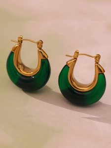 Detailed close-up of green resin U-shaped earrings with gold stainless steel plating