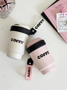 Overhead view of minimalist white and pink portable coffee cups with woven carry straps