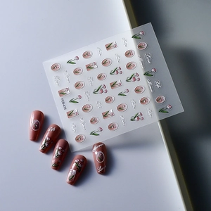 Detail view of FEB-475 embossed nail stickers with tulip flower and vintage frame designs