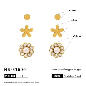 Three-pair set of gold stainless steel stud earrings featuring star and floral designs