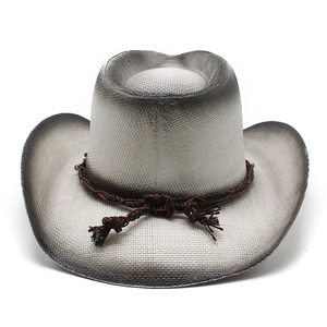 Detail of western fedora hat featuring black-white gradient weave and brown braided band