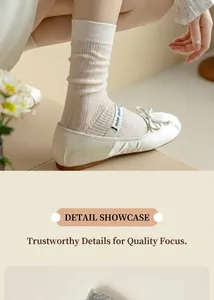 Detail of cream rib-knit mid-calf socks with vertical texture and soft elastic fabric