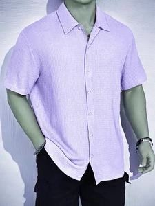 Detailed macro shot of purple short-sleeve shirt showing waffle texture and collar